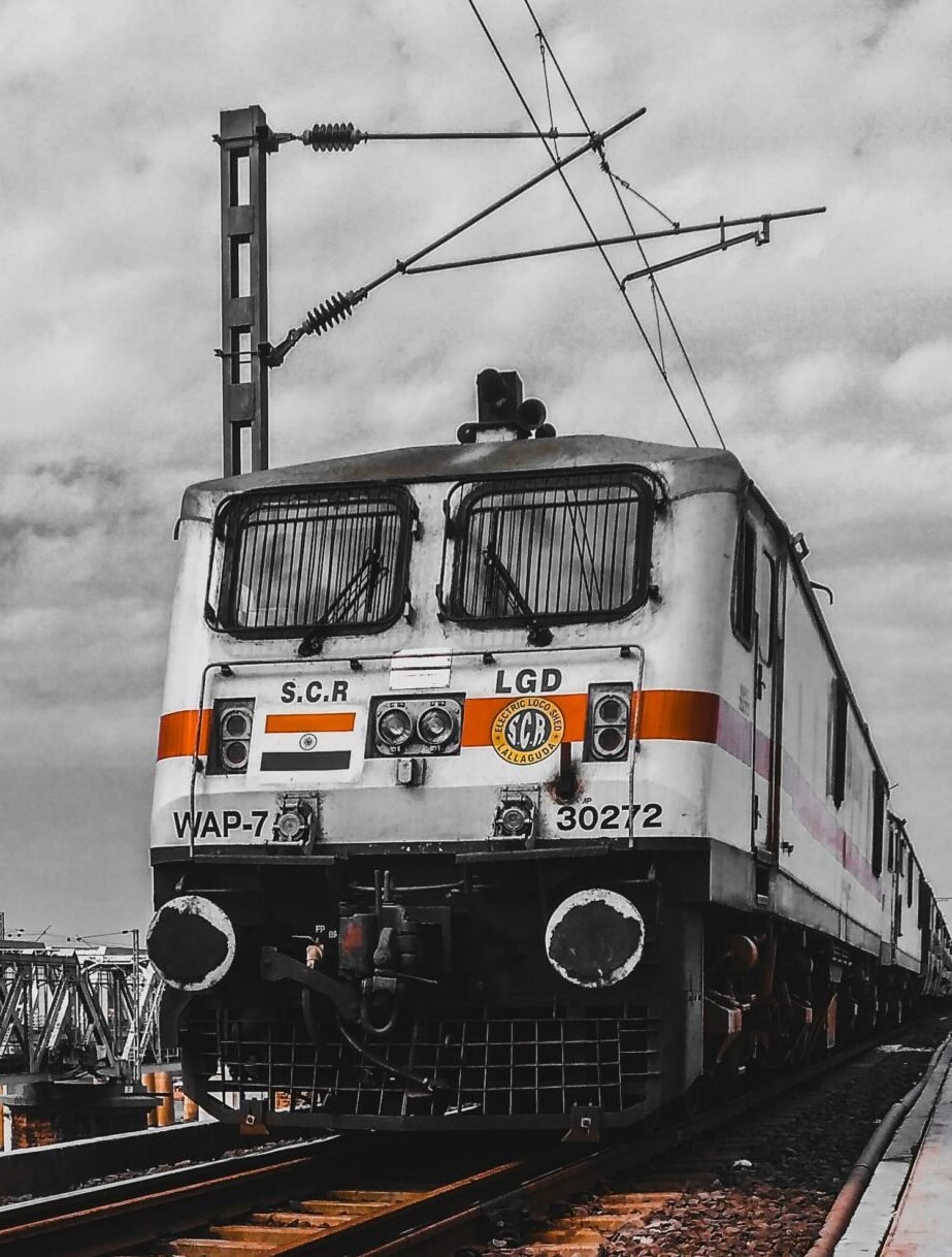 white and black train on rail tracks